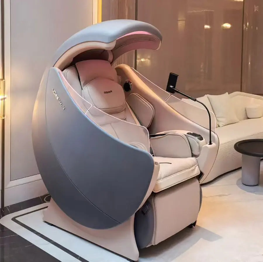 A modern egg-shaped premium OSIM uDream·AI massage chair in light gray and beige, shown in a luxurious indoor lounge setting with a sofa and warm ambient lighting.